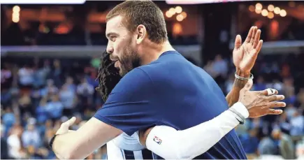  ??  ?? Grizzlies teammates Marc Gasol and Mike Conley hug at the half against the Timberwolv­es on Tuesday. MARK WEBER / THE COMMERCIAL APPEAL