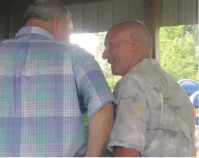  ?? (Photo by Danny P. Smith, SDN) ?? Former Sturgis High School football players Randall Bradberry, right, and Jimmy Smith visit during Saturday’s reunion.