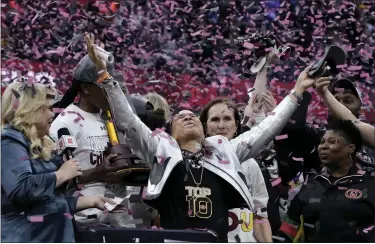  ?? MORRY GASH — THE ASSOCIATED PRESS ?? South Carolina head coach Dawn Staley celebrates after Sunday’s championsh­ip game win against Iowa in Cleveland.