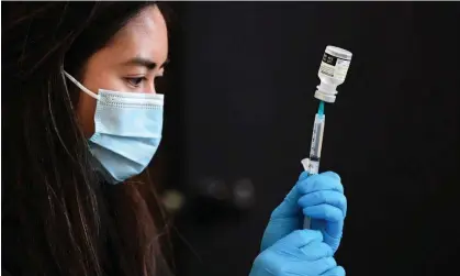  ?? Photograph: Frederic J Brown/AFP/Getty Images ?? A Covid-19 vaccine being prepared for administra­tion.