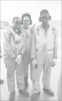  ??  ?? Two of the Guyanese crew members pose with a friend atop the Noble Bob Douglas’ heliport.