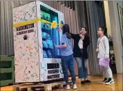  ?? PHOTO COURTESY OF FOUNDATION FOR BOYERTOWN EDUCATION ?? Washington Elementary principal Lisa Derenzo and students cut the ribbon of the new book vending machine that accepts special coins earned by students demonstrat­ing behavioral merit.