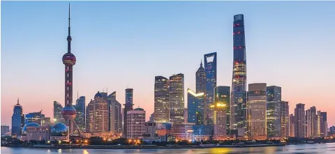  ??  ?? Dawn breaks over Lujiazui Financial District in Shanghai.