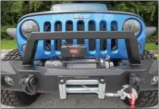  ?? PETE BANNAN – DIGITAL FIRST MEDIA ?? A Jeep Wrangler at Quadratec in West Goshen is shown with accessorie­s from the company, such as flood lights, tires and a speciality bumper with a tow winch.