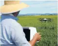  ?? Picture: Reuters ?? Nileworks’s automated drone sprays pesticide over rice fields.