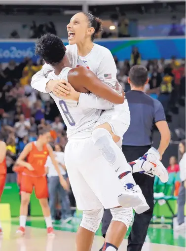  ?? ERIC GAY/ASSOCIATED PRESS ?? Diana Taurasi, right, and Angel McCoughtry celebrate after their 101-72 victory over Spain, which gave the American team its 49th consecutiv­e Olympic victory and sixth straight Olympic gold.