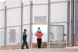  ??  ?? A U.S. Border Patrol agent escorts a family through the secondary fence back to Border Field State Park, San Diego, after visiting people in Friendship Park, Tijuana, along the U.S.-Mexico border in Tijuana, Baja Calif., on July 29, 2017.
