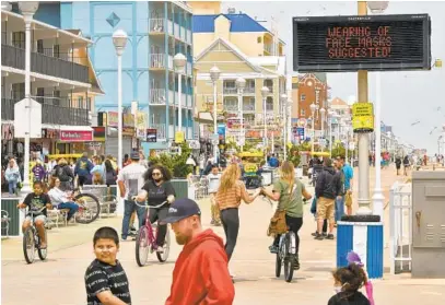  ?? AMY DAVIS/BALTIMORE SUN PHOTOS ?? Moderate crowds returned to Ocean City this weekend after Gov. Larry Hogan lifted the stay-at-home order.