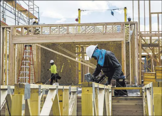  ?? Patrick Connolly Las Vegas Review-Journal @PConnPie ?? Workers build the frame of a Century Communitie­s home Wednesday in southwest Las Vegas.