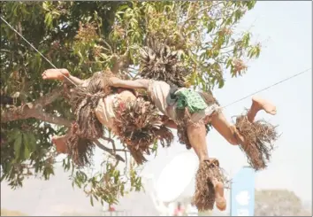  ??  ?? GOING AERIAL . . .Gule dancers perform an acrobatic dance on a wire