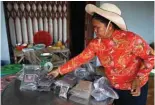  ?? ?? A worker packs peppercorn packets at a pepper farm in Kampot province.