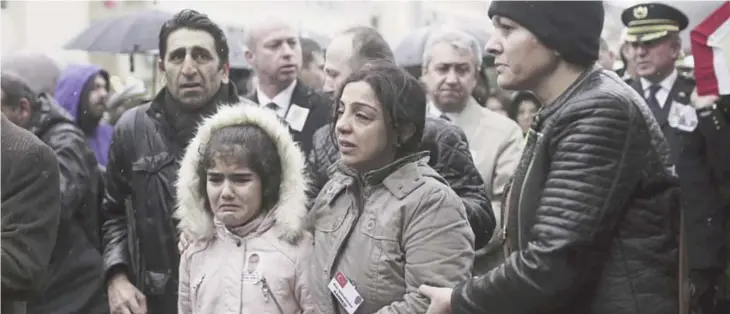  ??  ?? IZMIR: Family members accompany police officers carrying the coffin of police officer Fethi Sekin, who was killed in a car bomb attack Thursday, in the Aegean city of Izmir yesterday. —AP