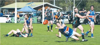  ??  ?? Bunyip’s Matthew Miller gets his handpass away after being taken down by Cora Lynn’s Ricky Clark as Zac Vansittart watches on. Bunyip’s Michael Whyte and Cora Lynn’s Chris McKay scuffle at left; Photograph­s: Tom Elton