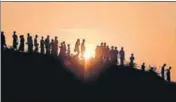  ??  ?? ■ The nowhere people: Rohingya refugees walk down a hillside in the Kutupalong refugee camp in Cox's Bazar, Bangladesh. AFP FILE