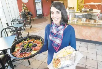 ?? THE MORNING CALL HARRY FISHER/ ?? Bon Appetit Cafe owner Wafa Khoury holds a garden salad and beef gyro inside the eatery at Ninth and Hamilton streets in downtown Allentown in January 2016. Khoury plans to open another breakfast and lunch restaurant, Wafa’s Kitchen, by early May at 515 Hamilton St. in downtown Allentown.