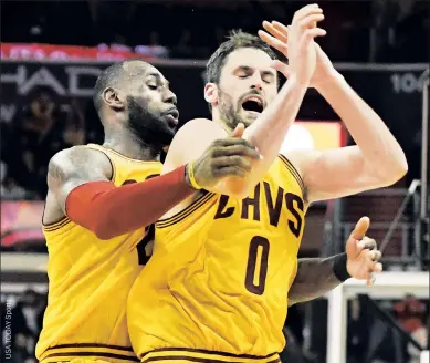  ??  ?? GOT YOUR BACK: Kevin Love and LeBron James celebrate in the fourth quarter of Monday night’s win in Washington. James hit a 3-pointer at the end of regulation to send the game into overtime before fouling out.