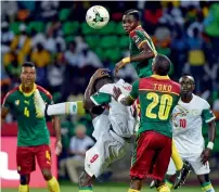  ?? AFP ?? Senegal’s Mame Biram Diouf (left) challenges Cameroon’s Ambroise Oyongo and Karl Toko Ekambi. —