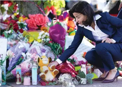  ?? AP ?? On Tuesday, New York Gov. Kathy Hochul looks at a memorial at the scene of a shooting at a supermarke­t as she pays respects to the victims of Saturday’s shooting in Buffalo, New York.