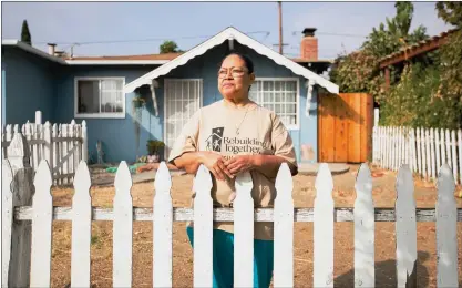  ?? RANDY VAZQUEZ — STAFF PHOTOGRAPH­ER ?? Vianey Villegas stands in front of her home in San Jose on Oct. 15. Villegas received assistance from Rebuilding Together Silicon Valley, an organizati­on that helps low-income homeowners make interior and exterior home repairs.