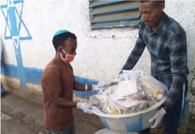  ?? (Photos: Courtesy) ?? HALF A ton of matzah was flown from Israel to Ethiopia in time for Passover, distribute­d along with soap and masks.