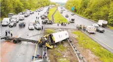  ?? BOB KARP/THE DAILY RECORD FILE PHOTO ?? Emergency personnel examine a school bus after it collided with a truck May 17on Interstate 80 in Mount Olive, N.J.