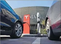  ?? Greg Baker AFP/Getty Images ?? A TESLA electric charging station in Beijing. In Europe, tens of thousands of charging stations are owned and operated by oil companies.