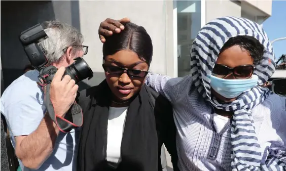  ?? Picture: Peter Wallis ?? One of the three COVID border breach accused Diana Lasu (left) leaves Brisbane Magistrate­s Court on Monday.