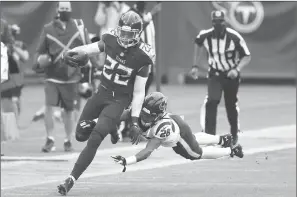  ?? WADE PAYNE/AP ?? Titans running back Derrick Henry avoids a tackle on a 53-yard gain on a screen pass in overtime Sunday.