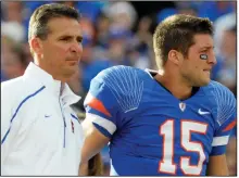  ?? (AP file photo) ?? Urban Meyer (left) and Tim Tebow, shown here before a Florida Gators game in 2009, are reportedly reuniting with the Jacksonvil­le Jaguars. The NFL Network reported Monday that Tebow will sign a one-year contract with the team.