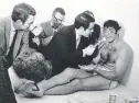  ?? AP FILE PHOTO ?? Jets quarterbac­k Joe Namath talks with reporters Jan. 13, 1969, as he rests on a training table in the team’s dressing room the morning after the Jets defeated the Baltimore Colts 16-7 in Super Bowl III in Miami, Fla.