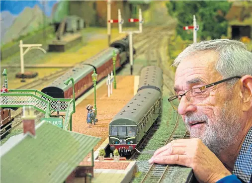  ?? Photograph by Jason Hedges ?? GAUGE FOR YOURSELF: Duncan MacRae from Elgin Model Railway Club club dusts off its Cragganmor­e model.