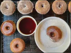  ?? (Arkansas Democrat-Gazette/Kelly Brant) ?? Boiled Cider Doughnuts are brushed with boiled cider and then tossed in spiced sugar.