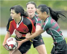  ?? CLIFFORD SKARSTEDT/EXAMINER ?? Holy Cross Hurricanes' Kyra Maybee and Melissa Duong right, slow down a Campbellfo­rd player during rugby action Oct. 21, 2014 at Holy Cross field in Peterborou­gh.