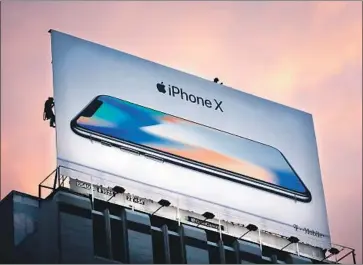  ?? Elijah Nouvelage AFP/Getty Images ?? APPLE projected revenue of $60 billion to $62 billion next quarter, exceeding analysts’ expectatio­ns of $59.6 billion. Its shares rose 3% in after-hours trading after rising 0.2% to $190.29 in regular trading Tuesday.