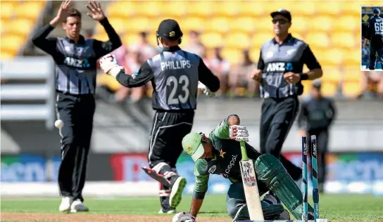  ?? PHOTOS: GETTY IMAGES ?? Mitchell Santner of New Zealand celebrates with Glenn Phillips after taking the wicket of Sarfraz Ahmed of Pakistan in a T20 internatio­nal earlier this season.