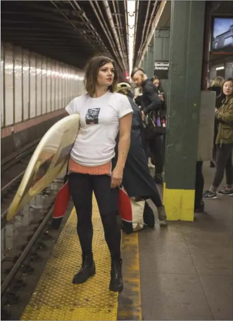  ?? COURTESY MARGARET PATTILLO PHOTOGRAPH­Y ?? Apolla Echino in her home of New York women’s guide to the world.” getting ready to head out for a surf trip. Echino has a docu-series called “A