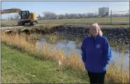  ?? PHOTOS BY MACOMB COUNTY PUBLIC WORKS OFFICE ?? Macomb County Public Works Commission­er Candice Miller stands alongside the Irwin Drain on the grounds of Selfridge Air National Guard Base.