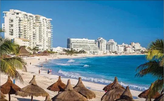  ?? BRAD CALKINS/DREAMSTIME/TNS ?? Resort hotels line the beach in Cancun, Mexico.