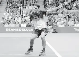  ?? AP ?? Roger Federer returns a shot from Feliciano Lopez during their match in New York on Saturday.