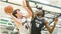  ?? PAUL W. GILLESPIE/CAPITAL
GAZETTE ?? Broadneck’s Devin McGowan shoots as Meade’s Shawn Jones defends during the Anne Arundel County championsh­ip game Feb. 18.