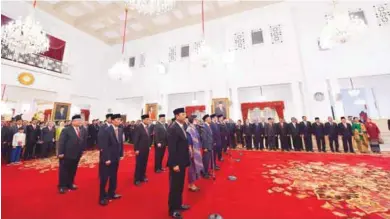  ?? – AFP ?? NEW TEAM: The newly-appointed ministers during an inaugurati­on ceremony at the presidenti­al palace in Jakarta on Wednesday.