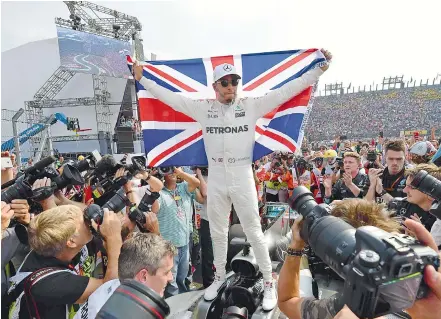  ?? — AFP ?? Mercedes’ Lewis Hamilton celebrates after winning his fourth Formula One world title despite finishing the Mexican Grand Prix in ninth place, at the Hermanos Rodriguez circuit in Mexico City on Sunday.