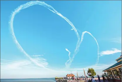  ??  ?? Italian Air Force’s Frecce Tricolori team drew a heart shape in the sky during their aerial display in Kuwait. (Hatem Al-Sheikh – KUNA)