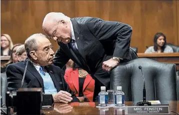  ?? DREW ANGERER/GETTY ?? Sen. Chuck Grassley, R-Iowa, left, talks with Sen. Patrick Leahy, D-Vt., Wednesday at a hearing for Jeff Sessions.