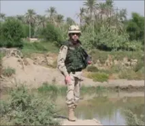  ?? Courtesy of John C. Burns ?? Army Col. John C. Burns stands near the Tigris River in the central Iraq city of As-Samawah during the 2003 U.S. invasion. A year later, he was injured by a roadside bomb in Baghdad, suffering shoulder and traumatic brain injuries and, later, post-traumatic stress disorder.