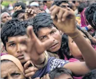  ?? AP PHOTO ?? Myanmar’s Rohingya ethnic minority refugees reach for food distribute­d by Bangladesh­i volunteers near Cox’s Bazar’s Gundum area, Bangladesh, Sunday.