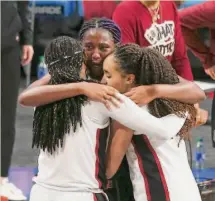  ?? Kin Man Hui/San Antonio Express-News 2021 ?? Stanford’s Haley Jones (right) and Fran Belibi console South Carolina’s Aliyah Boston after their title game victory.