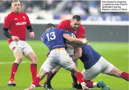  ??  ?? Ken Owens’s progress is halted by two French defenders during Wales’s victory in Paris