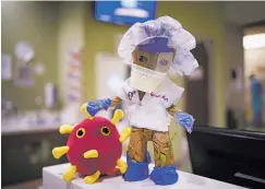  ?? PHOTOS BY GABRIELA CAMPOS THE NEW MEXICAN ?? BELOW, RIGHT: A Groot doll sporting its own personal protective equipment stands at one of the nursing stations in the Frost 19 unit.