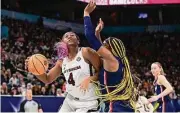  ?? Ben Solomon / NCAA Photos via Getty Images ?? South Carolina’s Aliyah Boston, left, drives against UConn’s Aaliyah Edwards during last season’s national championsh­ip game.